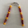 Elongated red, white and yellow glass beads